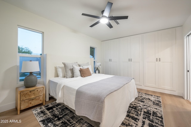 8215 E Virginia Ave, Scottsdale, AZ 85257 - bedroom featuring light wood finished floors, a ceiling fan, and baseboards