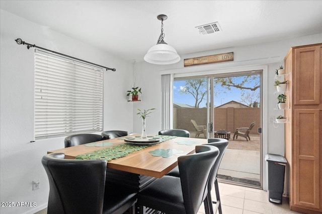 dining area with light tile patterned floors and visible vents