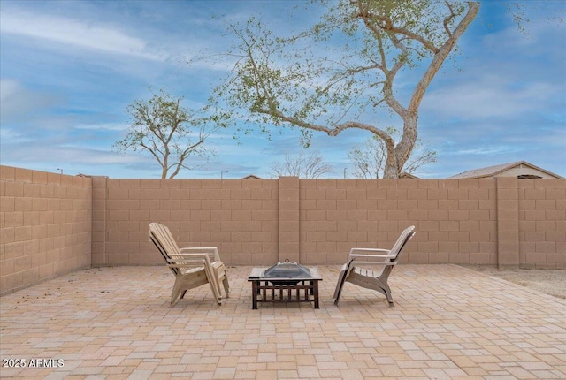 view of patio / terrace featuring an outdoor fire pit and fence