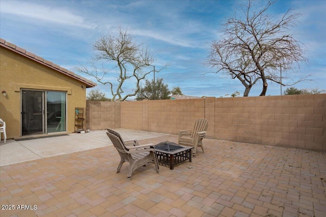 view of patio with a fire pit and a fenced backyard