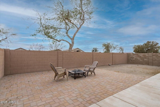 view of patio featuring a fire pit and a fenced backyard