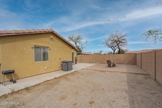 view of yard featuring central air condition unit, a fenced backyard, and a patio