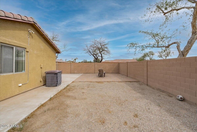 view of yard featuring a patio, a fenced backyard, and central air condition unit