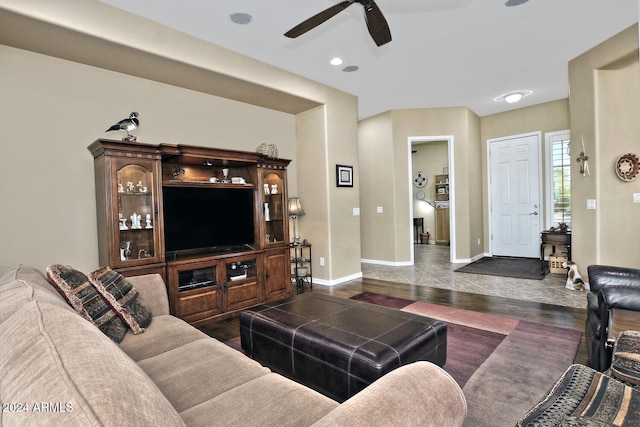 living room featuring ceiling fan and dark hardwood / wood-style floors