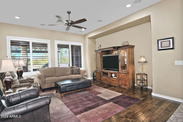 living room featuring ceiling fan and dark wood-type flooring