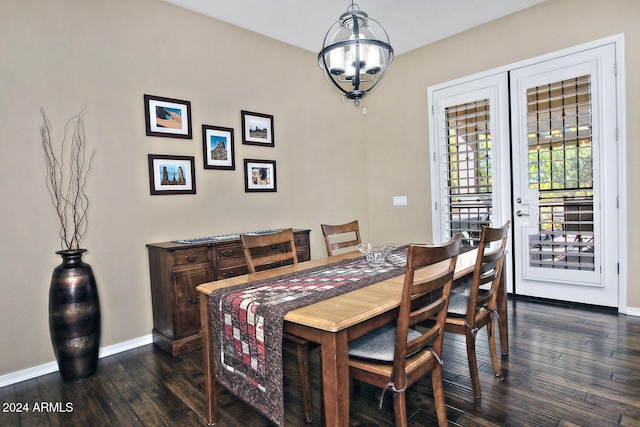 dining room featuring dark hardwood / wood-style flooring and an inviting chandelier