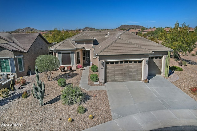 view of front of home featuring a mountain view and a garage