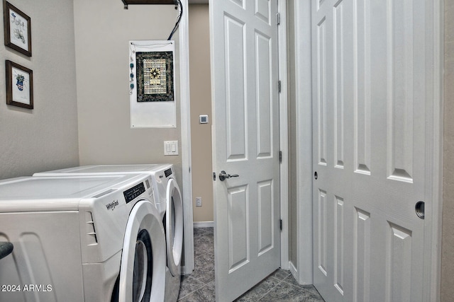 laundry room featuring separate washer and dryer and light tile patterned floors