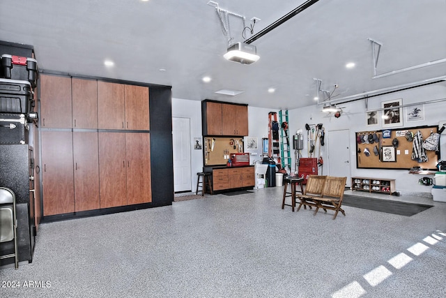 garage featuring a workshop area and a garage door opener