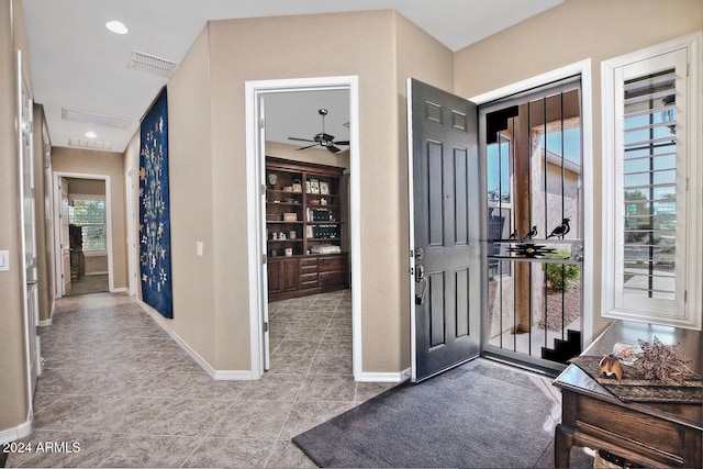 tiled entryway featuring ceiling fan