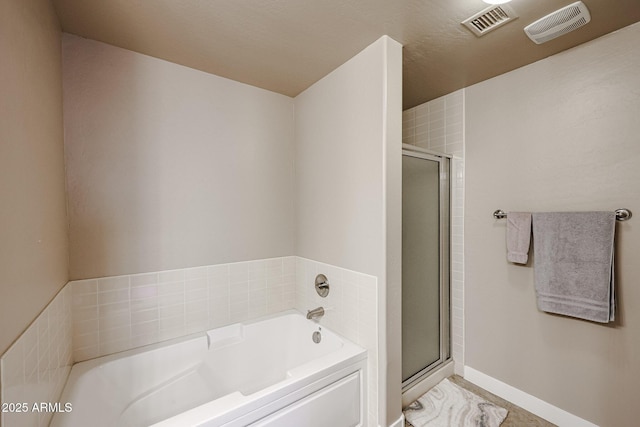 bathroom featuring shower with separate bathtub