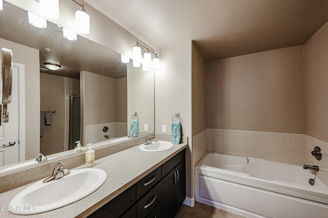 bathroom with vanity, tile patterned flooring, and a tub