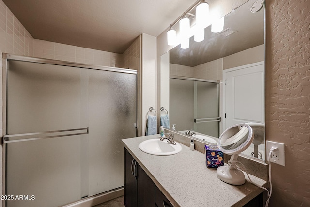 bathroom featuring vanity and a shower with shower door