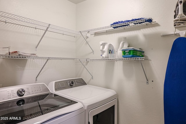 laundry area with washing machine and clothes dryer