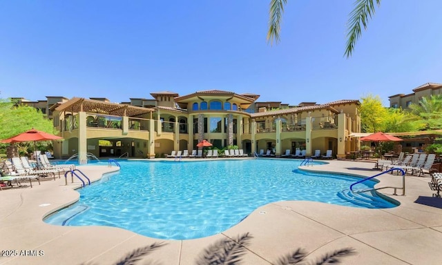 view of swimming pool with a patio