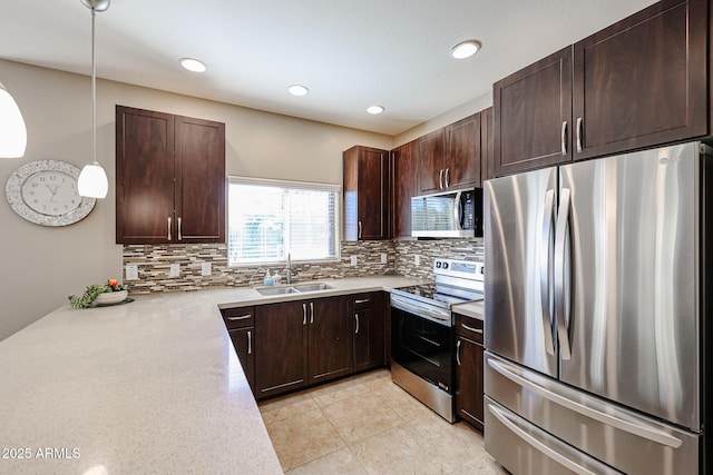 kitchen featuring tasteful backsplash, hanging light fixtures, stainless steel appliances, and sink