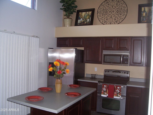 kitchen featuring appliances with stainless steel finishes, light countertops, and dark brown cabinetry