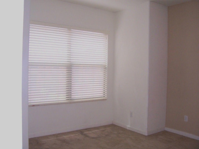 spare room with baseboards