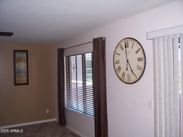 carpeted empty room featuring plenty of natural light and baseboards