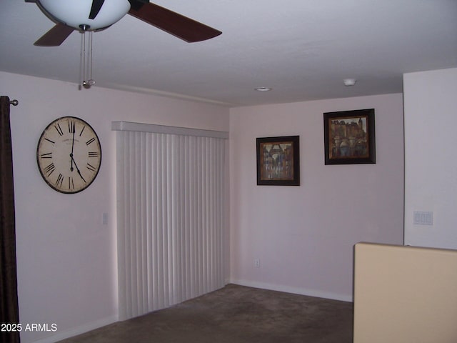 spare room featuring carpet floors, a ceiling fan, and baseboards