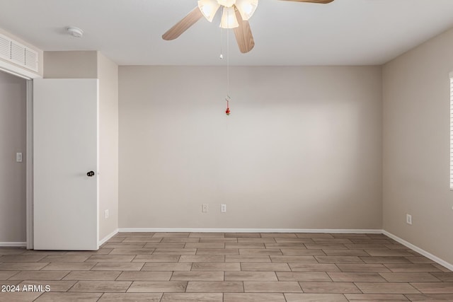 empty room featuring light wood-type flooring and ceiling fan