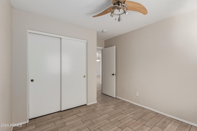 unfurnished bedroom featuring a closet, light hardwood / wood-style flooring, and ceiling fan