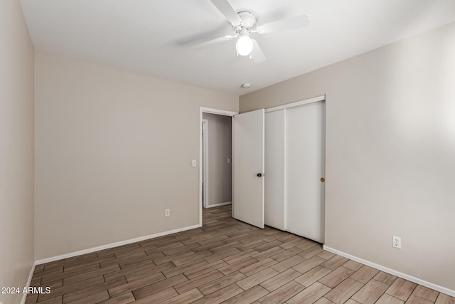 unfurnished bedroom with ceiling fan, a closet, and light hardwood / wood-style floors