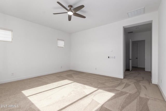 unfurnished room featuring ceiling fan and light carpet