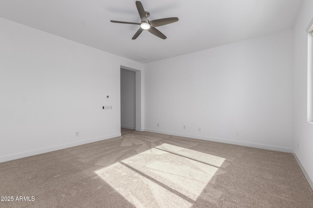 carpeted spare room with ceiling fan