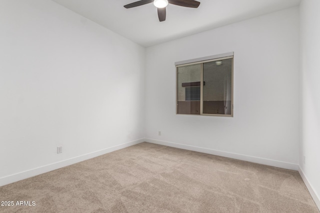 unfurnished room with ceiling fan and light carpet