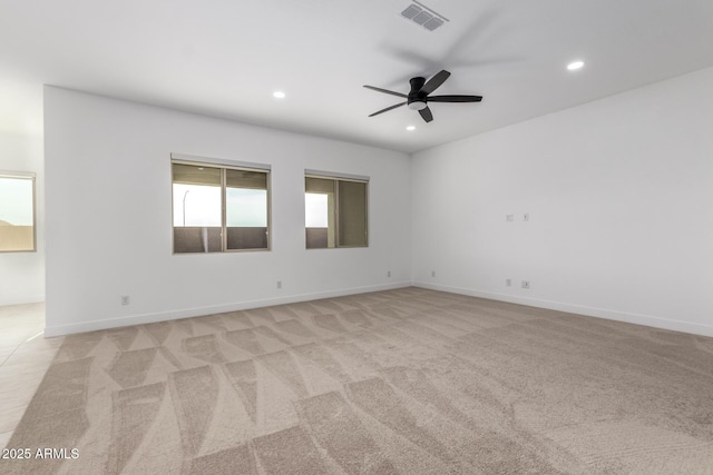 empty room featuring light colored carpet and ceiling fan