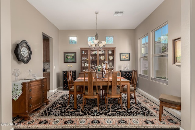 dining space featuring a notable chandelier