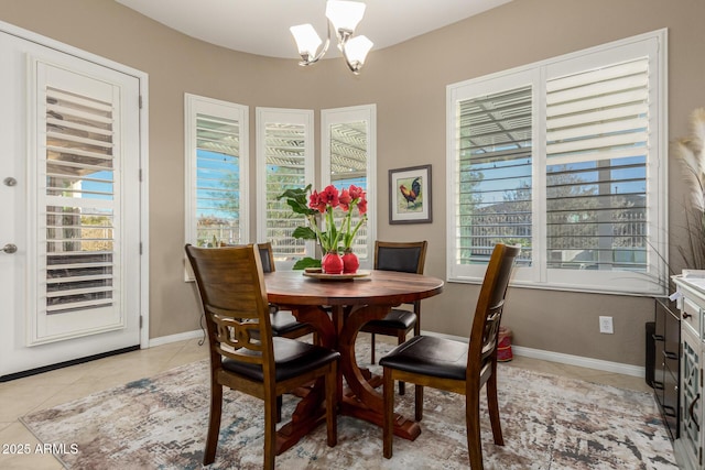 dining space with a wealth of natural light, an inviting chandelier, and light tile patterned flooring