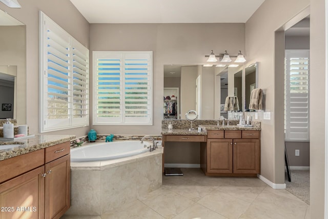 bathroom featuring tiled bath, tile patterned floors, and vanity