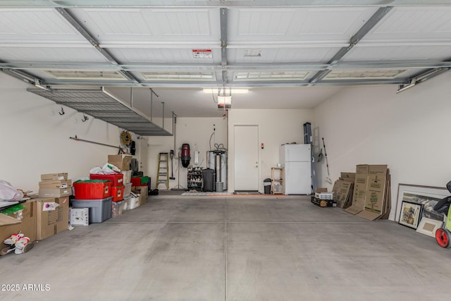 garage with white fridge and a garage door opener