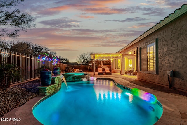 pool at dusk with an outdoor hangout area, a patio area, and an in ground hot tub