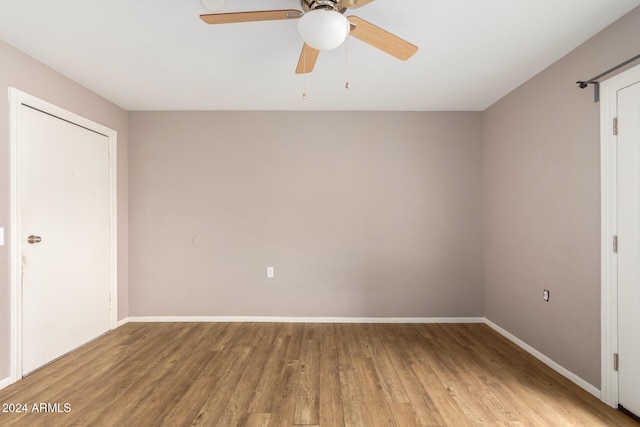 unfurnished bedroom featuring hardwood / wood-style flooring and ceiling fan