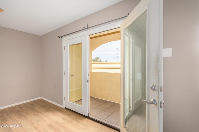 entryway with light hardwood / wood-style floors and french doors