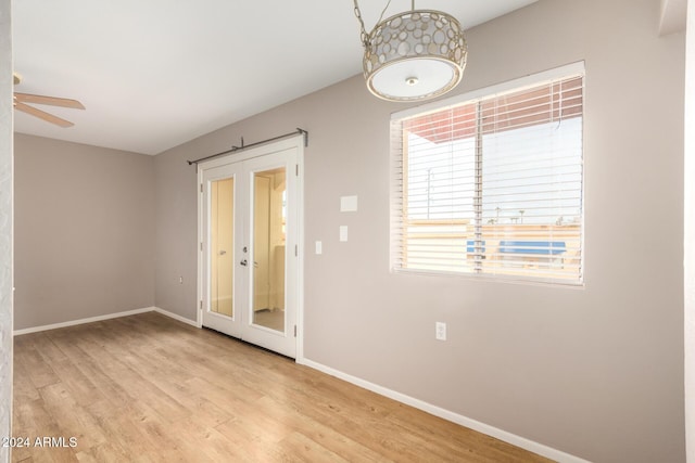 unfurnished room with ceiling fan and light wood-type flooring