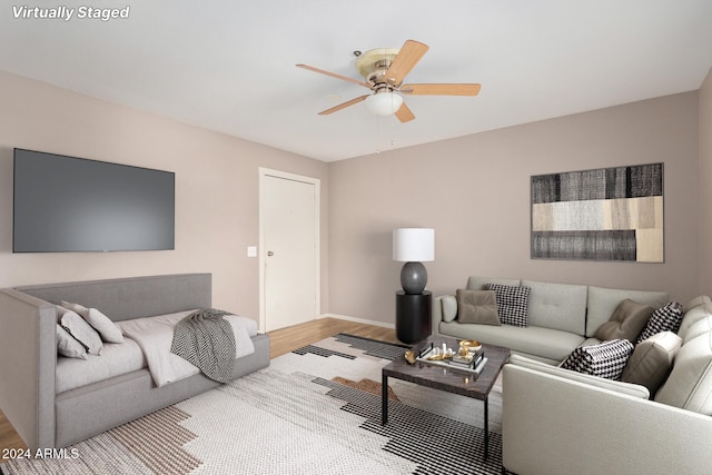 living room with light hardwood / wood-style floors and ceiling fan