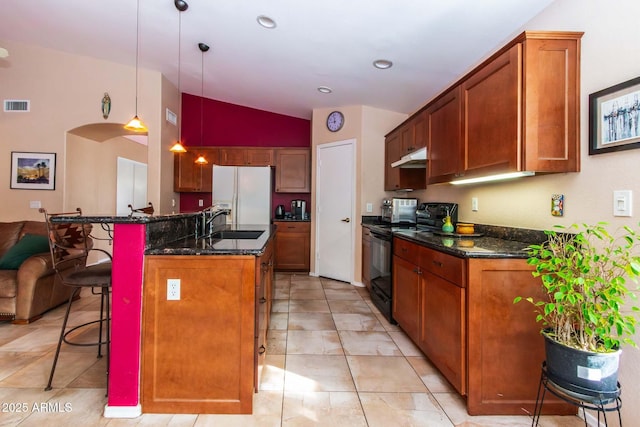 kitchen featuring a breakfast bar, sink, hanging light fixtures, white refrigerator with ice dispenser, and black range with electric cooktop