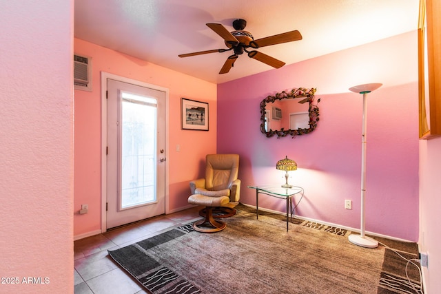 living area with light tile patterned floors and ceiling fan