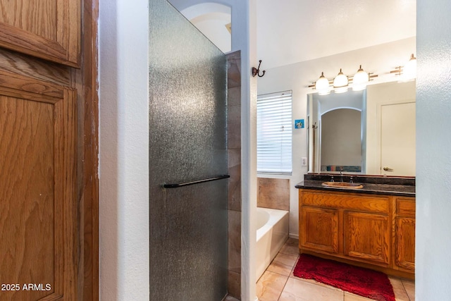 bathroom featuring vanity, independent shower and bath, and tile patterned flooring