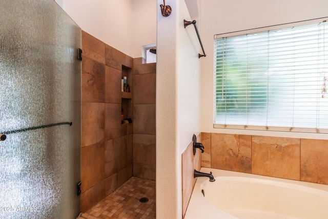 bathroom featuring independent shower and bath