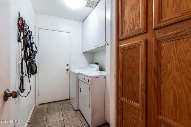 clothes washing area with cabinets and washer and dryer