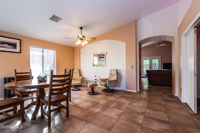 tiled dining room with ceiling fan and lofted ceiling