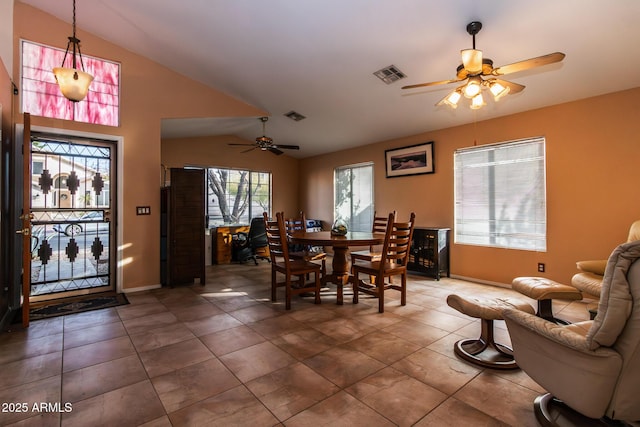 tiled dining area featuring vaulted ceiling and ceiling fan