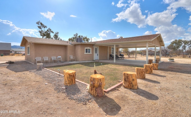 rear view of property featuring a patio area