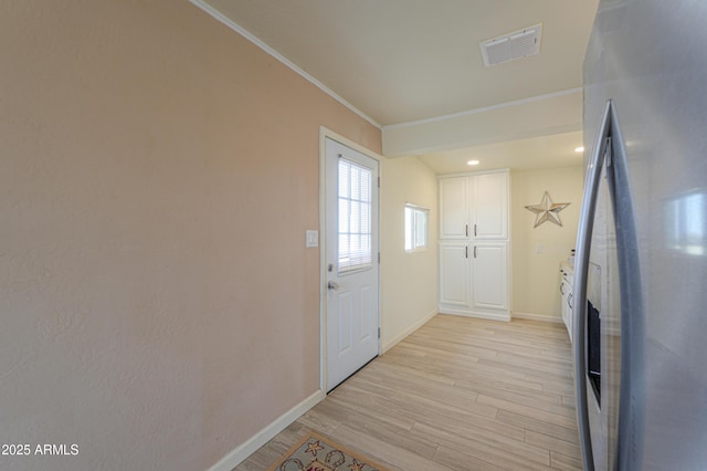 doorway featuring light hardwood / wood-style flooring and ornamental molding