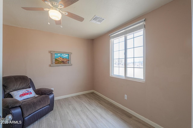 sitting room featuring ceiling fan and light wood-type flooring